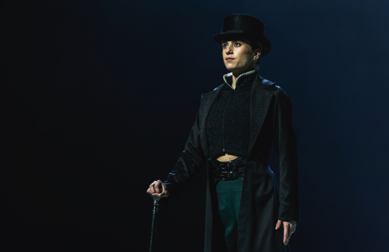 Gentleman Jack: dancer Gemma Coutts wears black frock coat and top hat and stands holding her silver topped cane