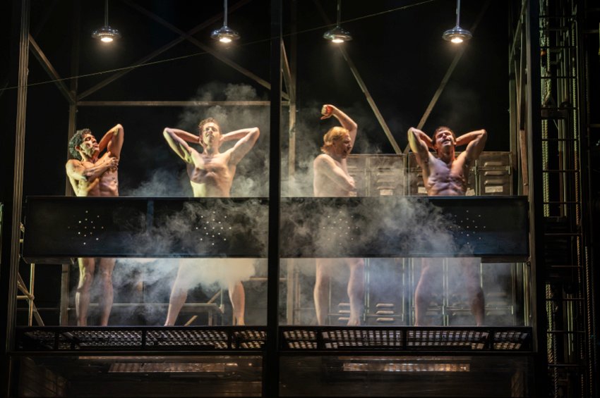 The Car Man: Four naked men simulate having a shower on a steamy platform