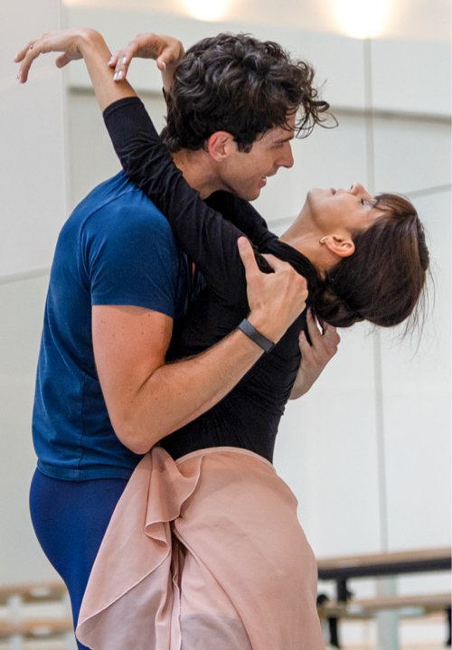 Mayara Magri and Reece Clarke in practice costumes rehearsa Manon.  He wolds her close, the leans back, all strength exhausted